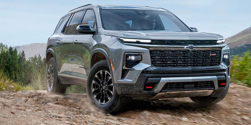 Gray Chevrolet Traverse Z71 SUV driving off-road on a dirt path.