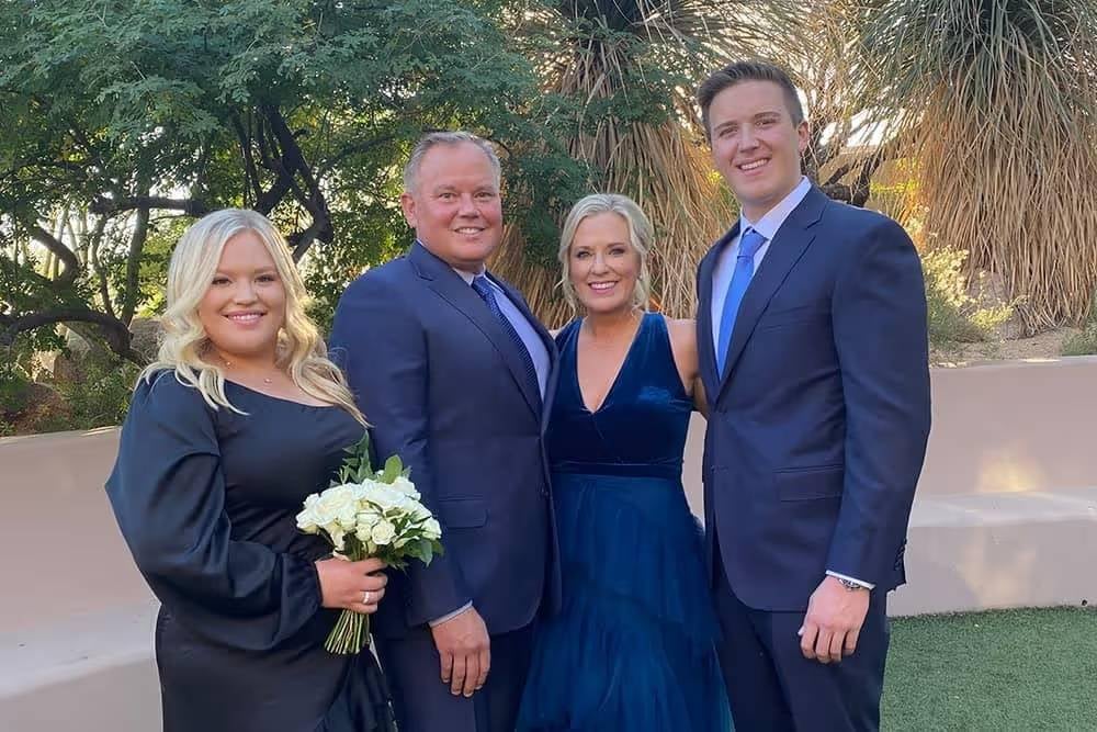 Group of four people dressed formally outdoors